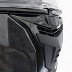 Close-up of a black motorcycle helmet with a clear visor on a white background